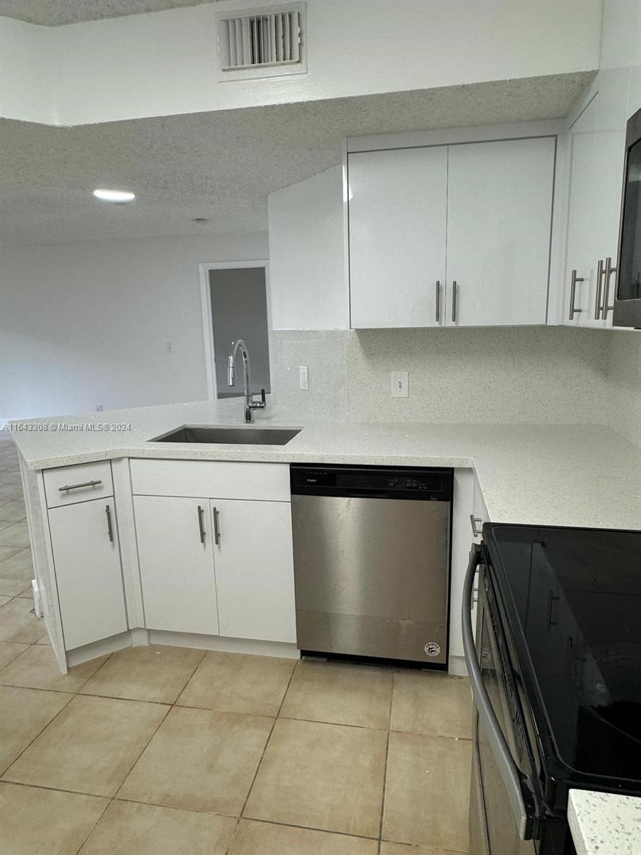 a kitchen with white cabinets