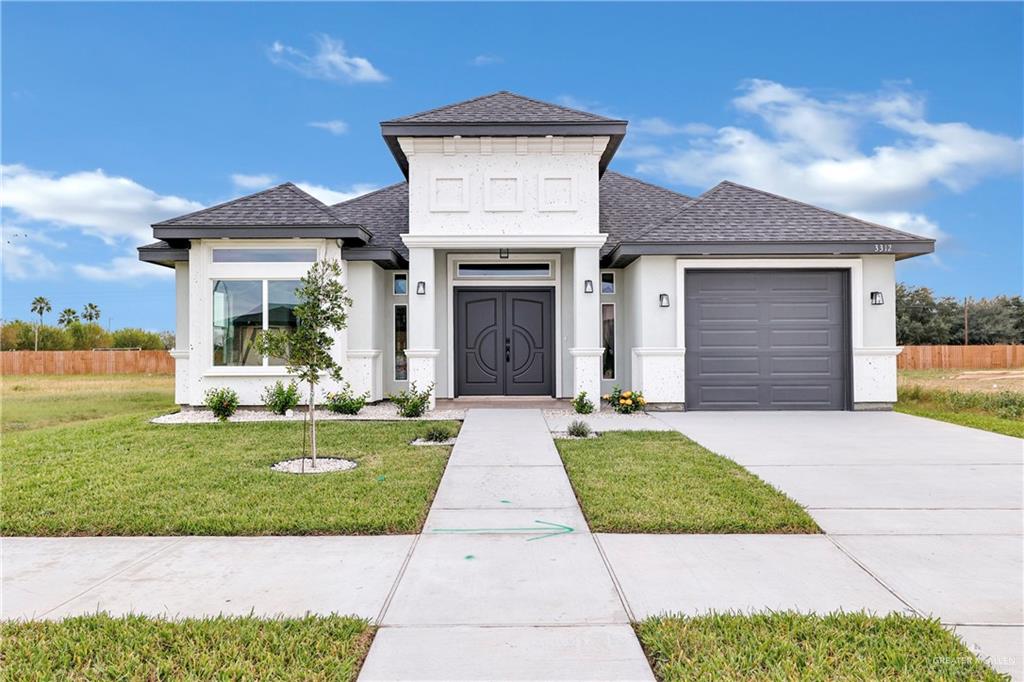 a front view of a house with a garden and yard