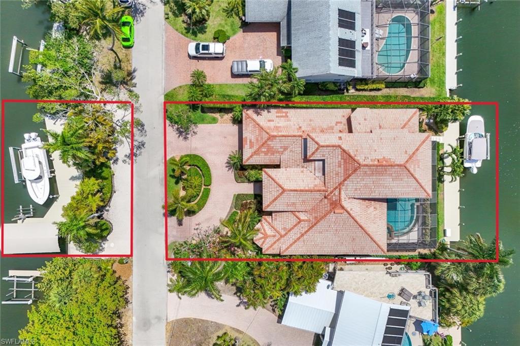 an aerial view of a house with a yard and a large tree