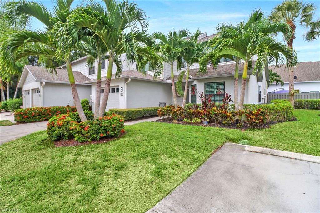 Single story home with a garage and a front lawn