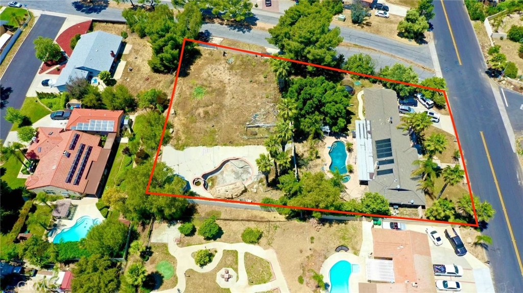 an aerial view of a house with a yard and garden