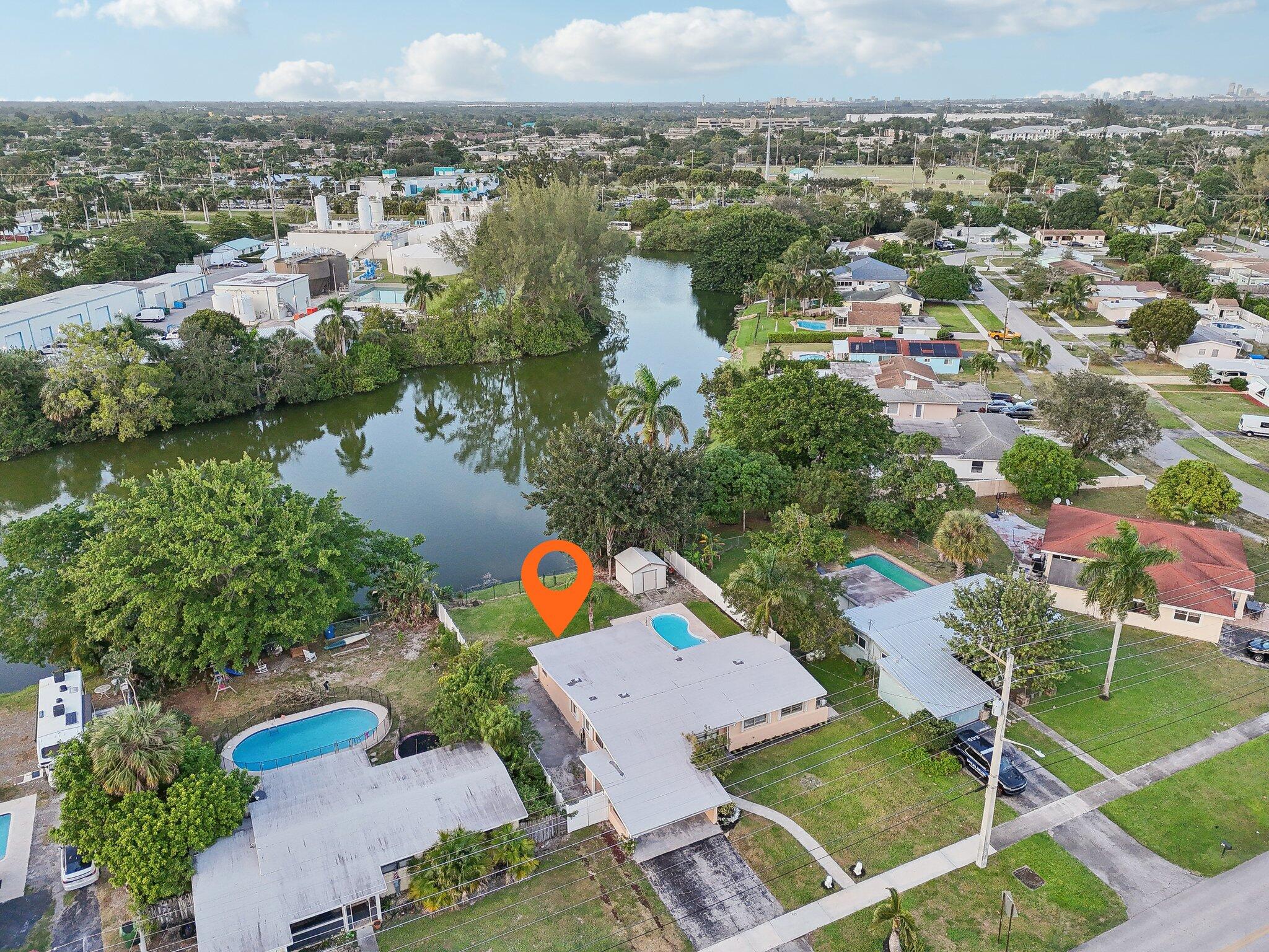 an aerial view of a house with a lake view