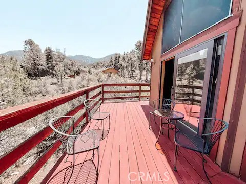 a view of balcony with wooden floor and seating space