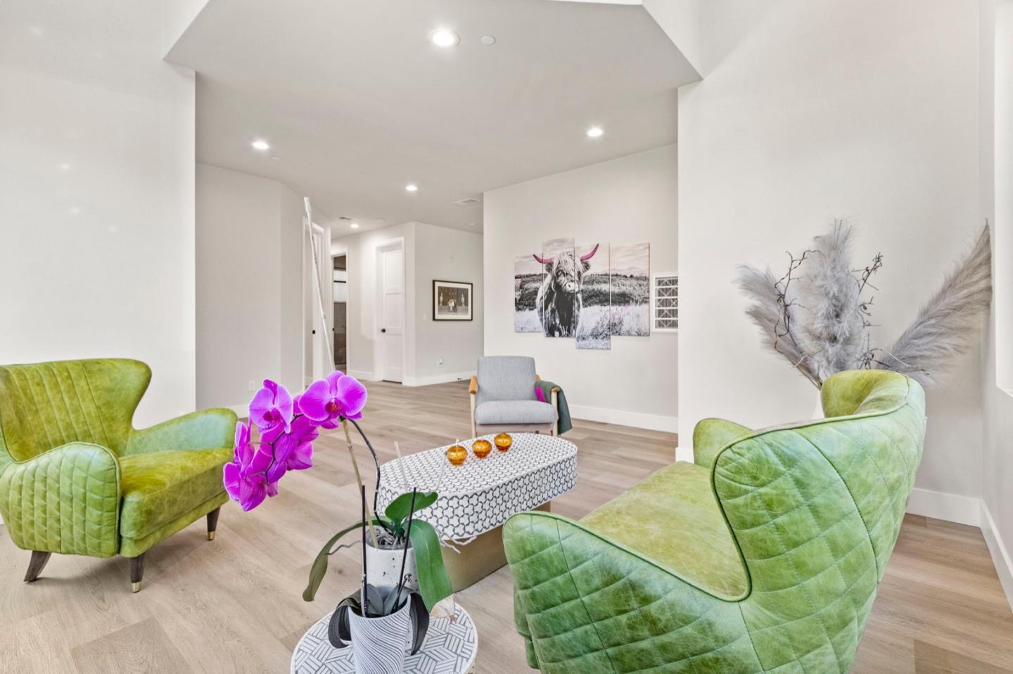 a living room with furniture flowerpot and a chandelier