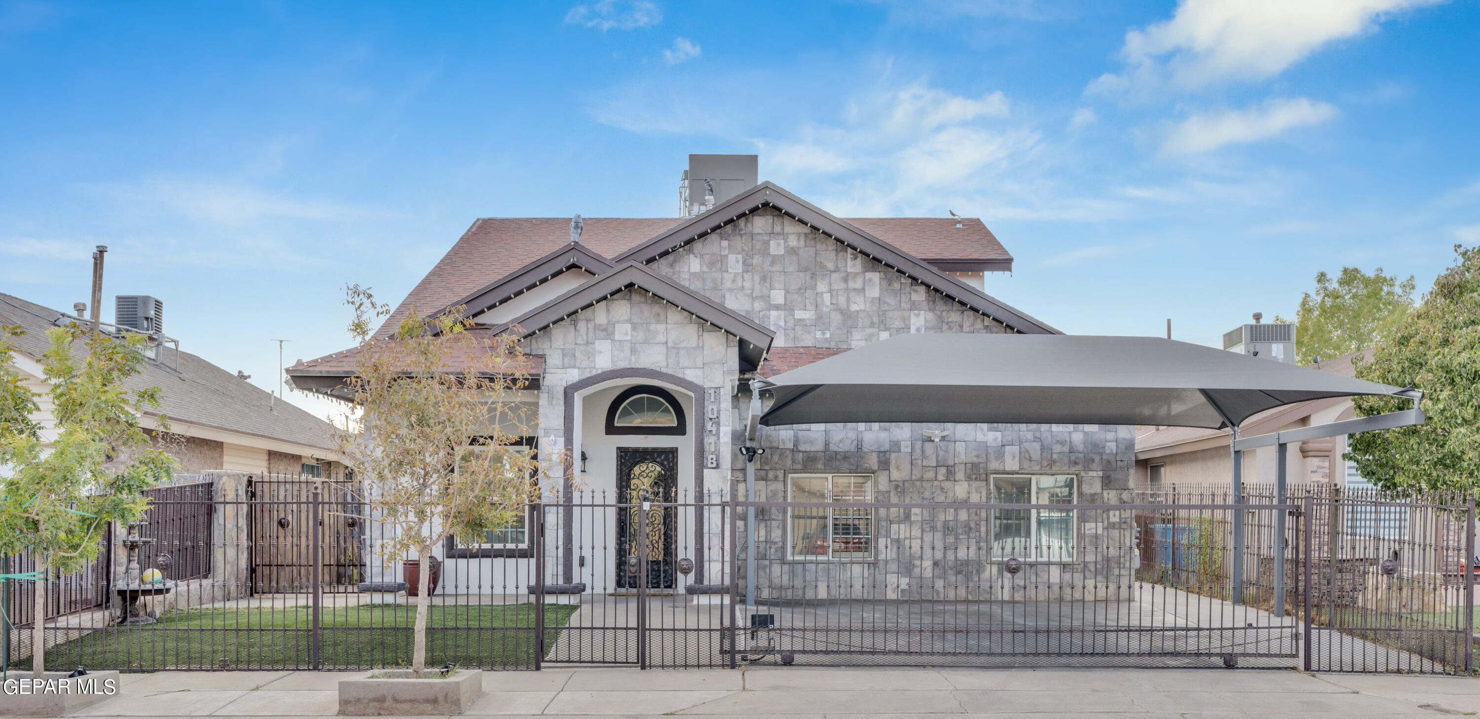 a front view of a house with garden