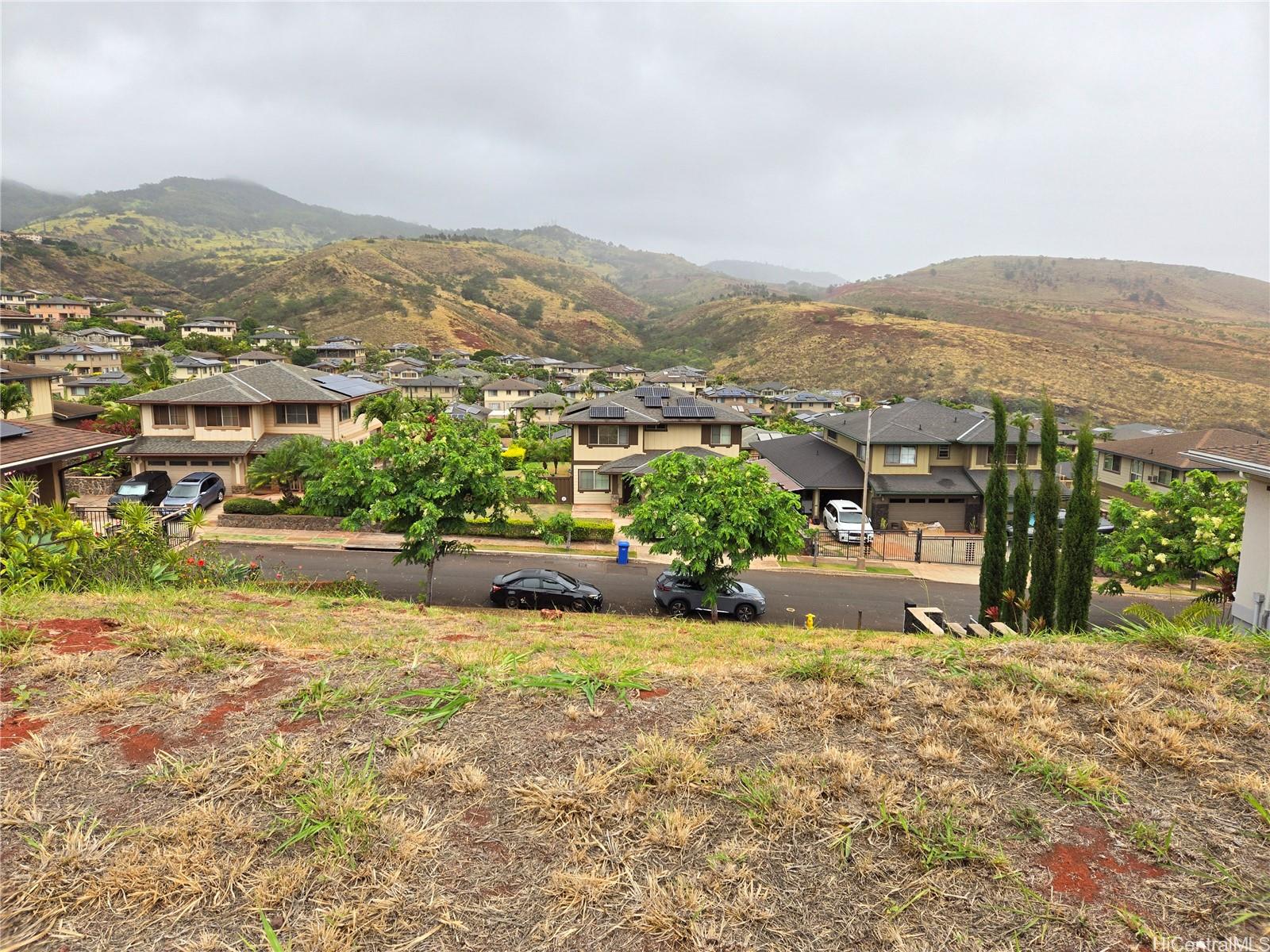 an aerial view of residential houses with outdoor space and trees