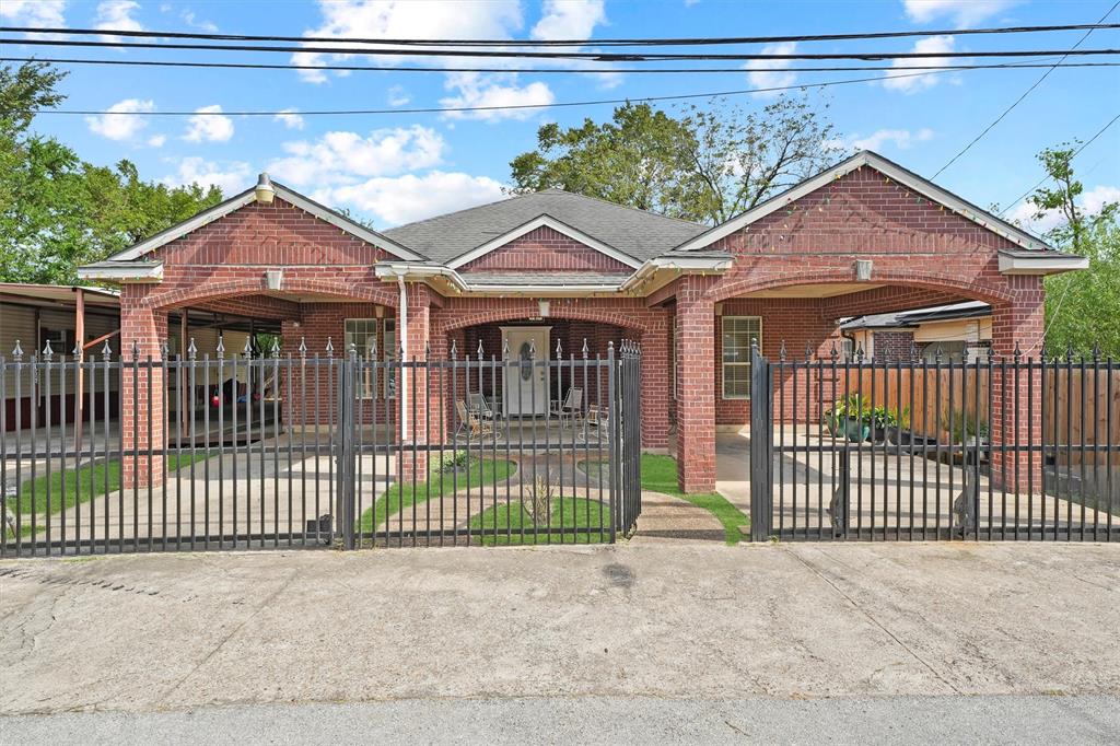 a view of a house with a wooden fence