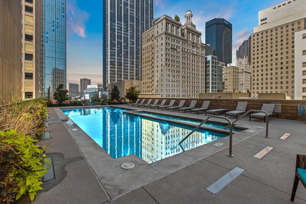 Pool at dusk featuring a patio