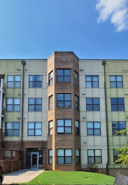 a view of an apartment with a large window and a yard