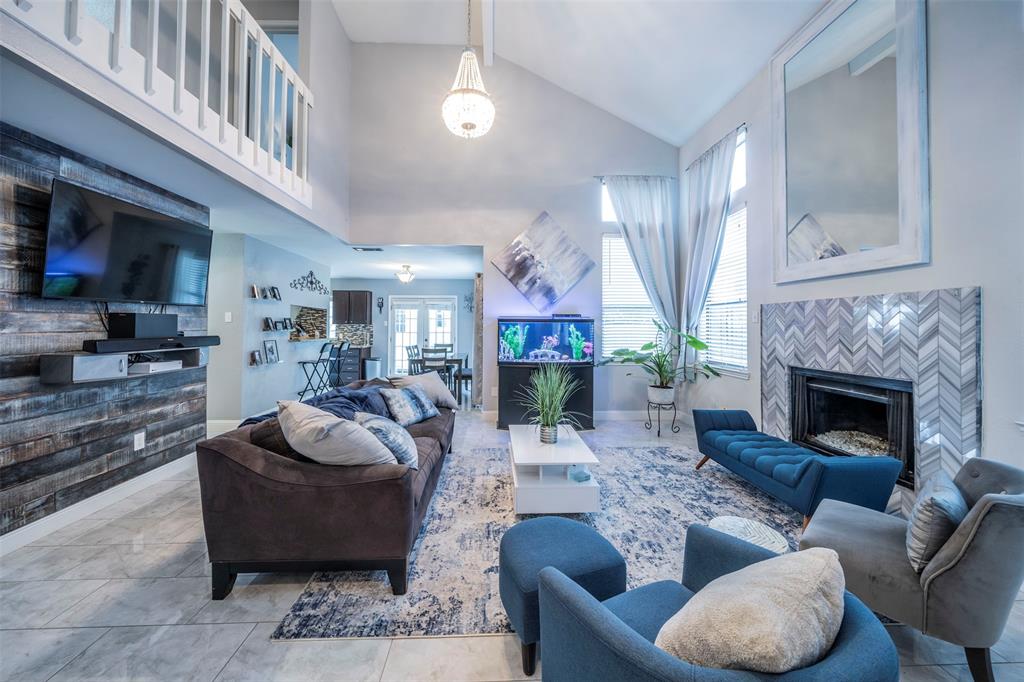 a living room with furniture a fireplace and a flat screen tv