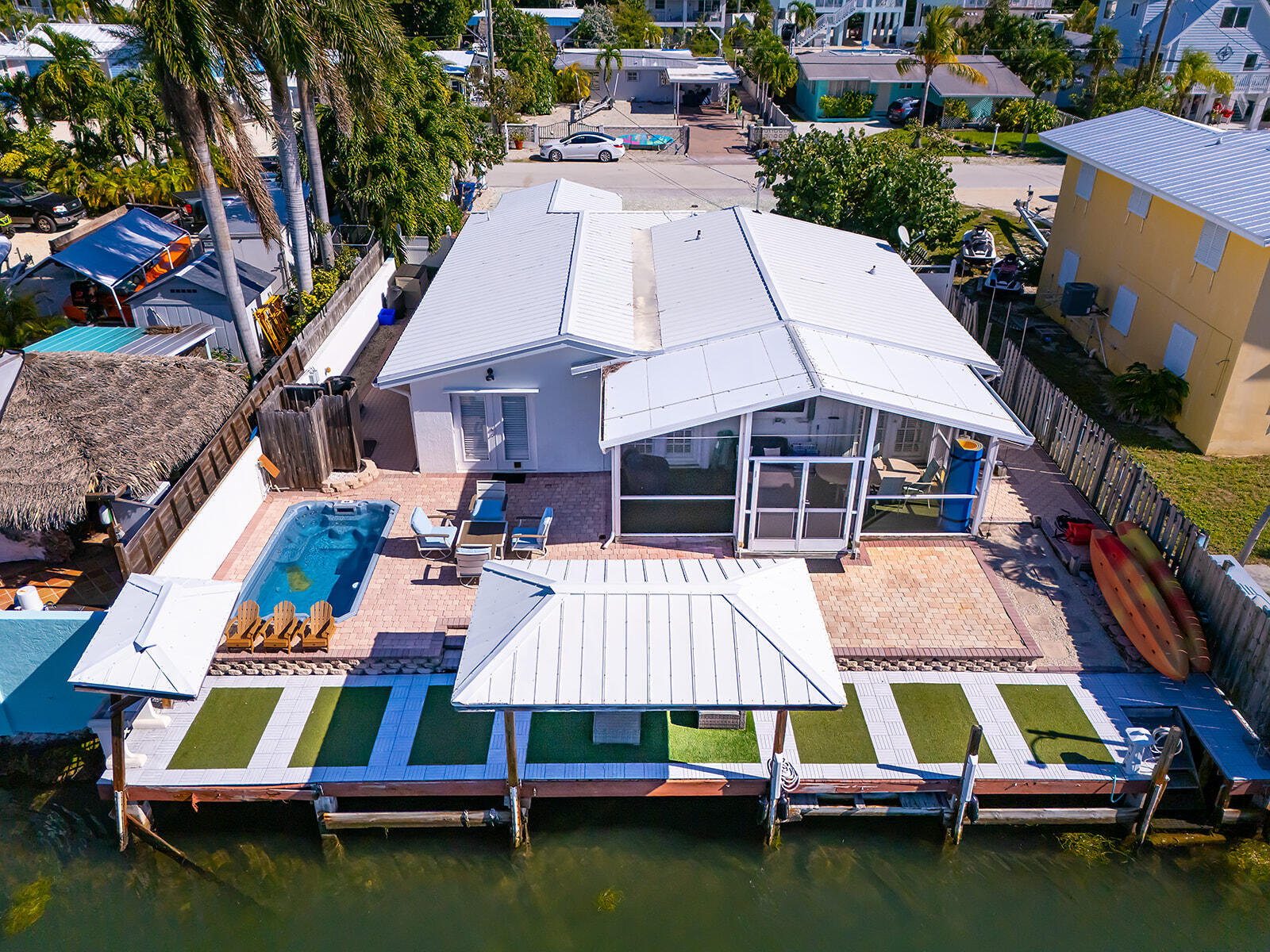 an aerial view of multiple houses with swimming pool