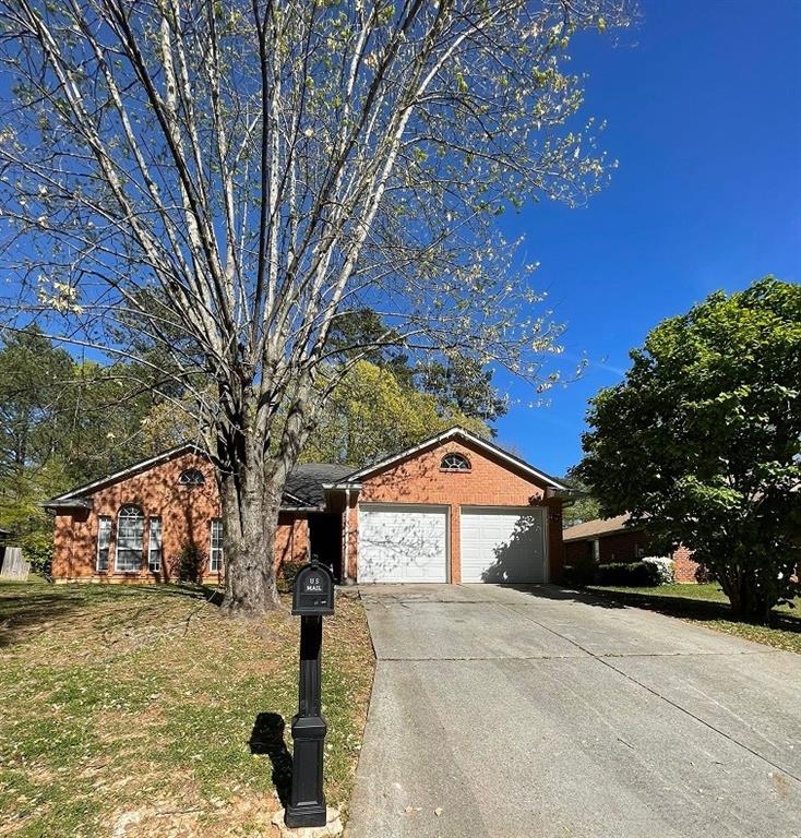 a front view of a house with trees