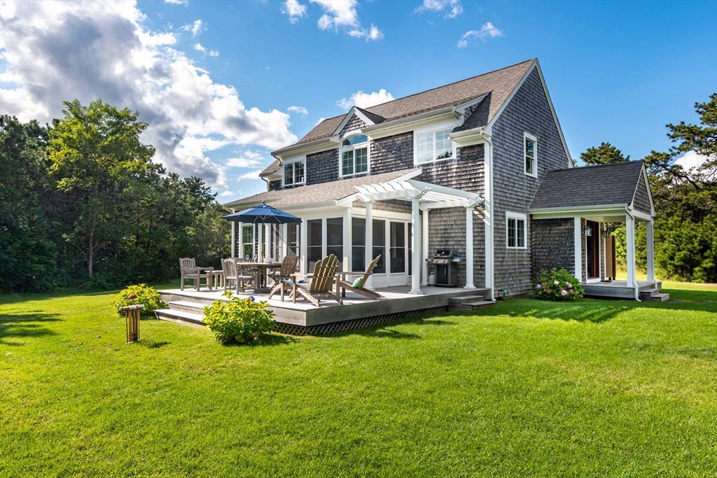 a front view of a house with swimming pool having outdoor seating