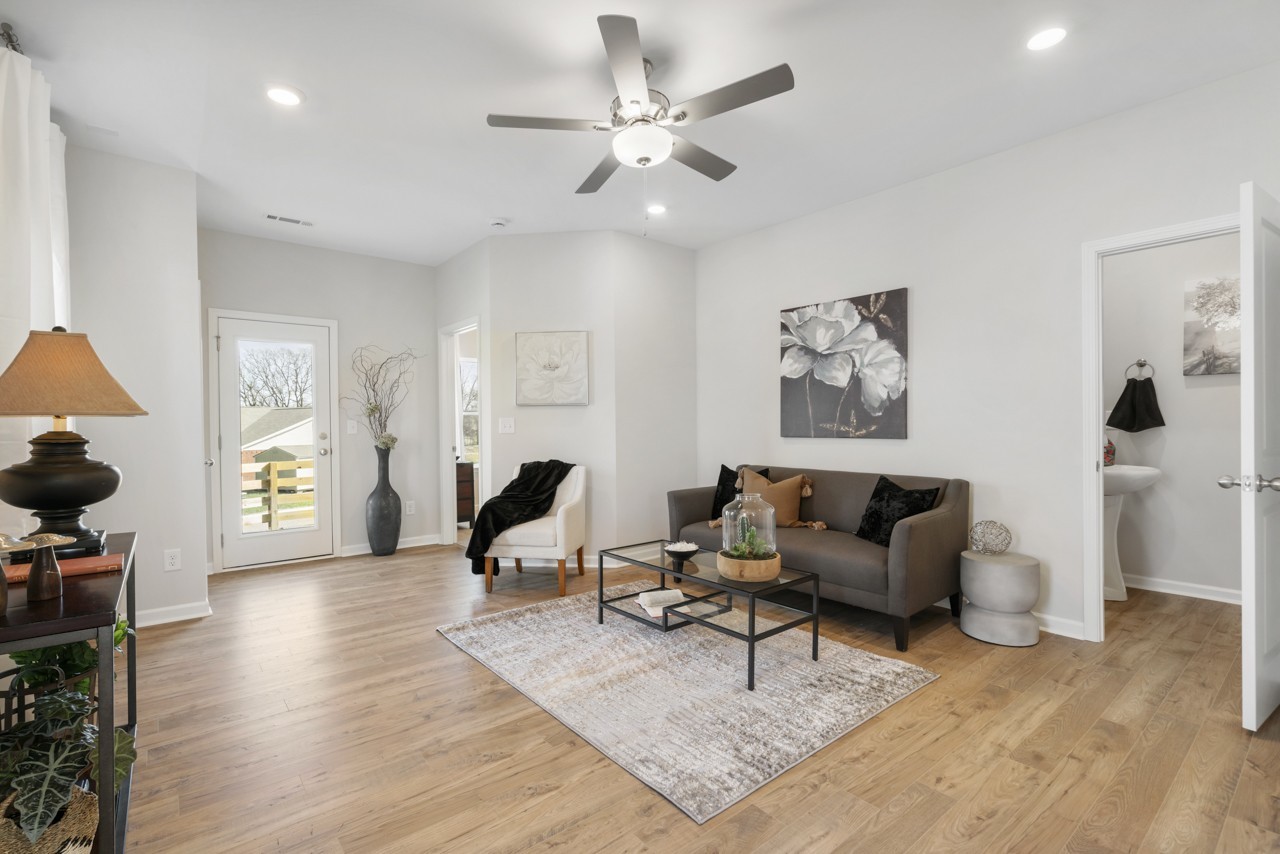 a living room with furniture and wooden floor