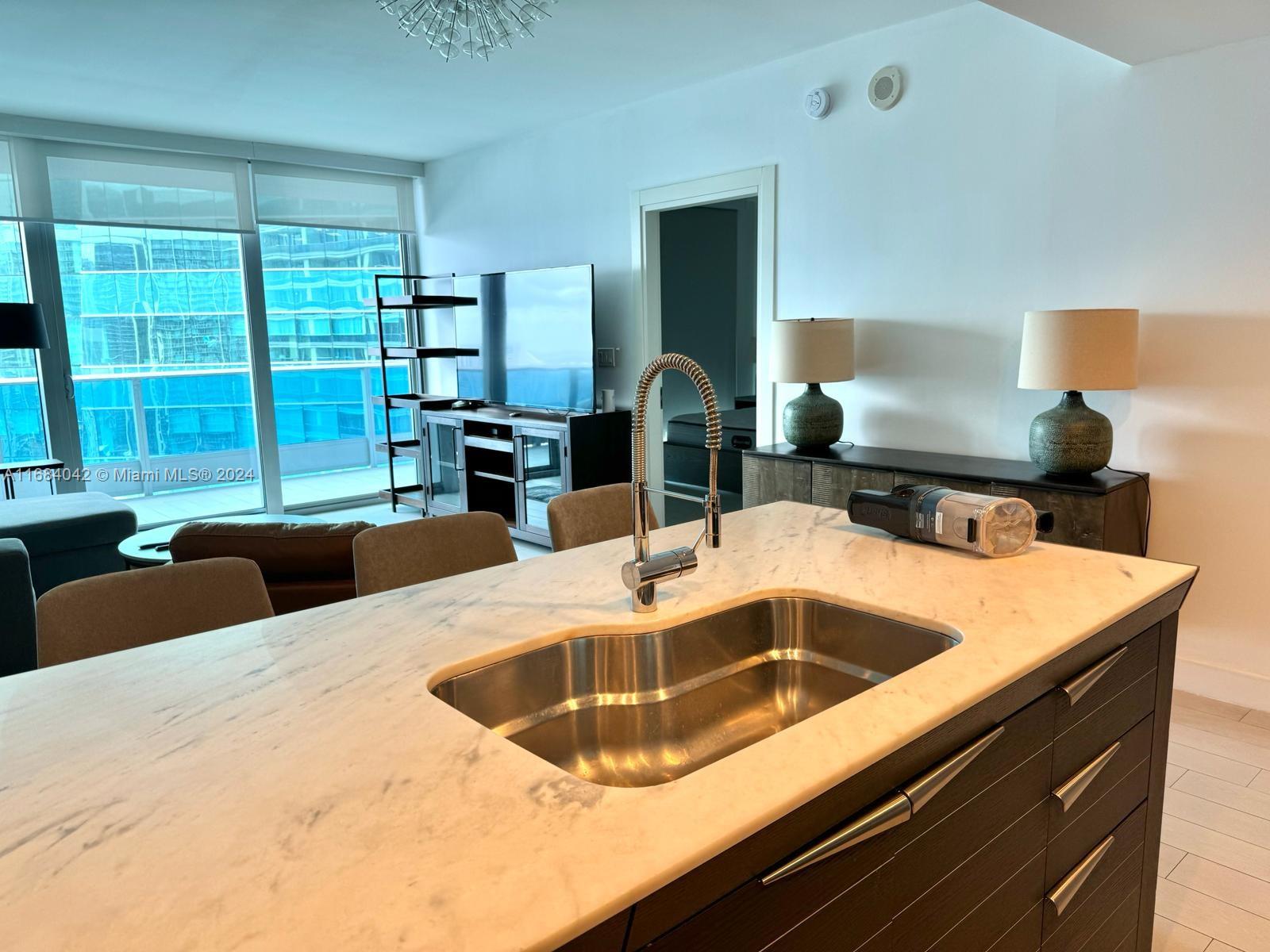 a kitchen with a sink and a large window