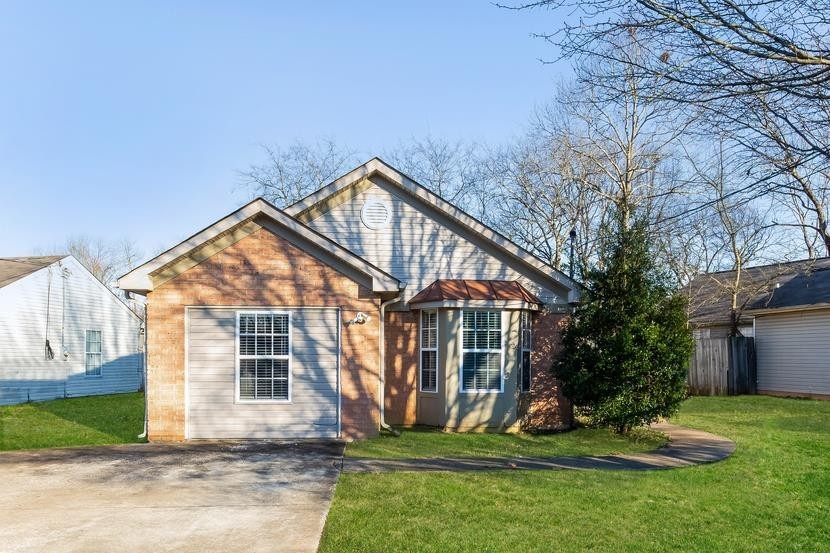 a front view of a house with a yard and garage