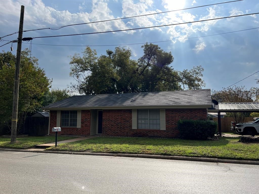 a front view of a house with a garden and plants