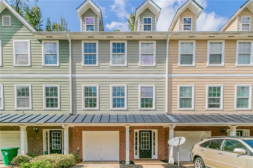 a front view of a house with a parking space