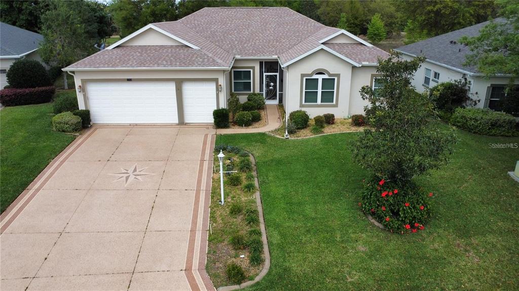 a front view of house with a garden