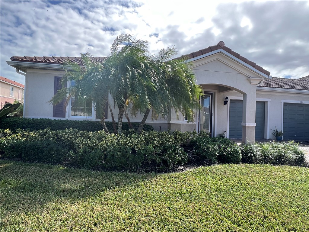 a front view of a house with garden