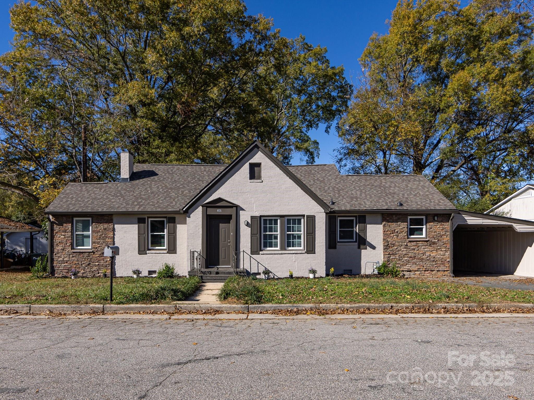 a front view of a house with a garden