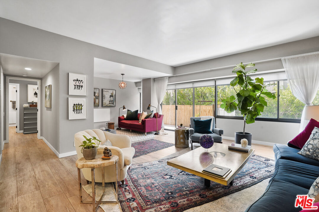 a living room with furniture and large windows