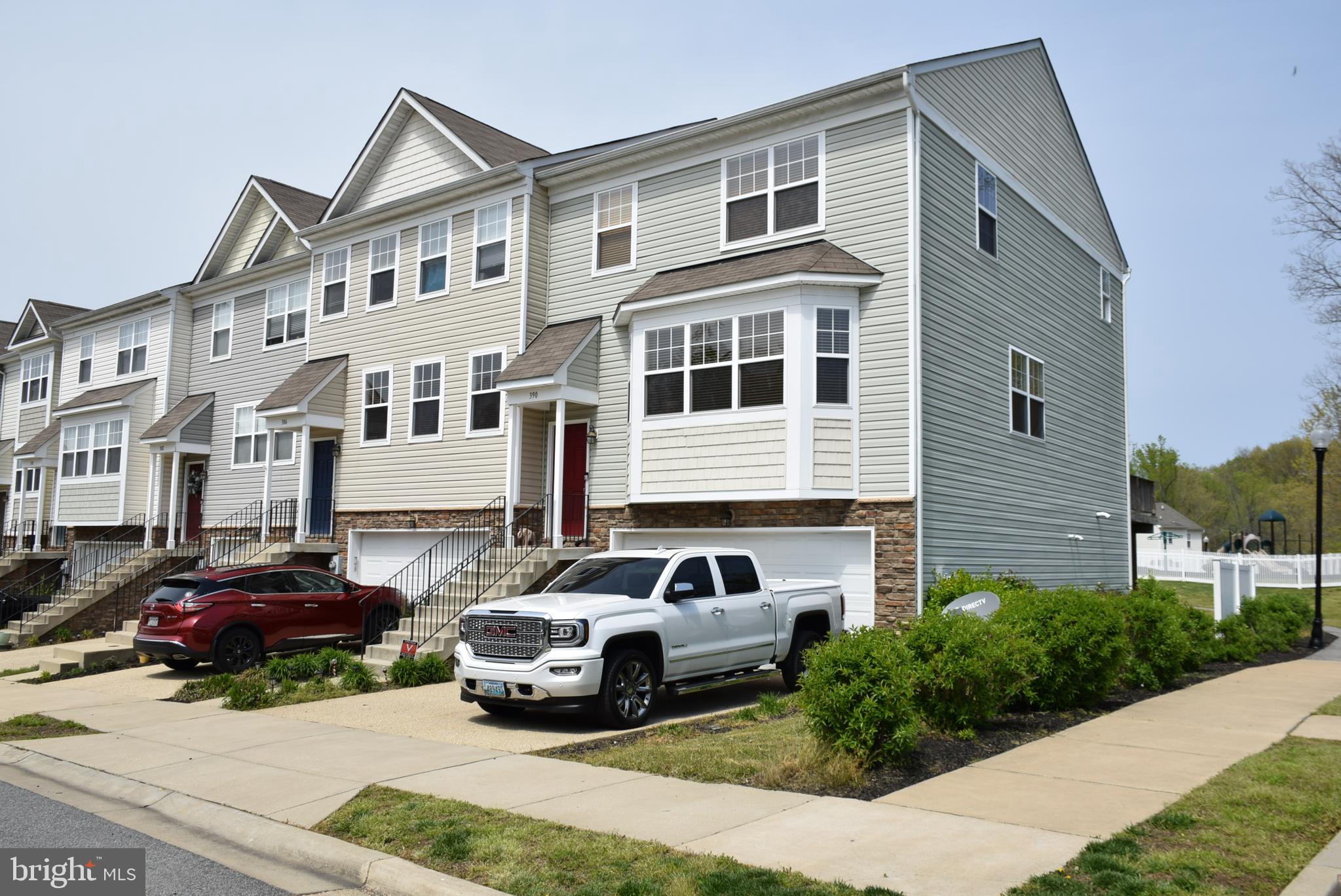 a couple of cars parked in front of a house