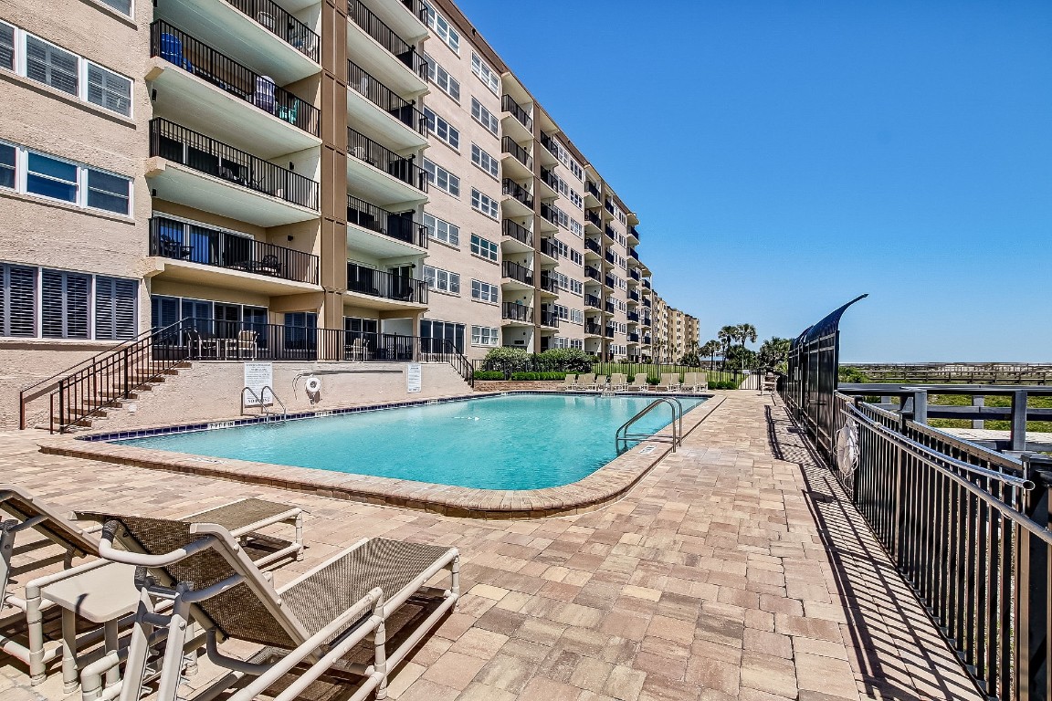 a view of a swimming pool with a lounge chairs