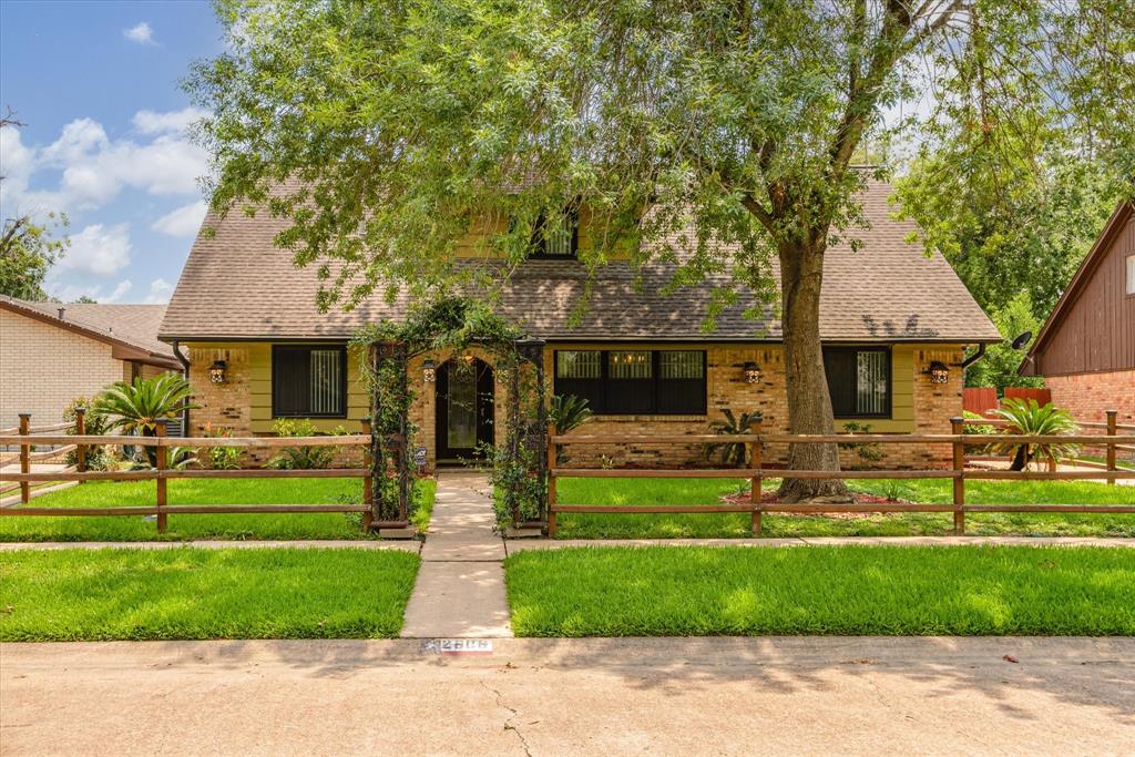 a front view of house with yard and green space