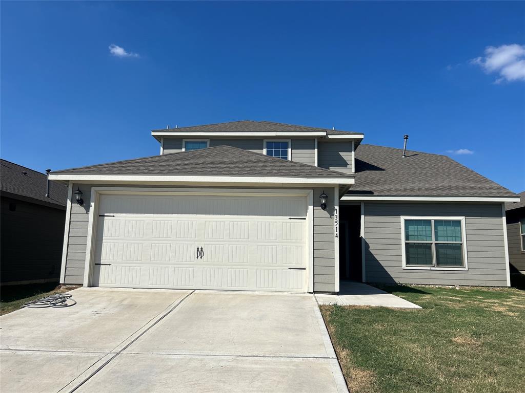 a front view of a house with garage