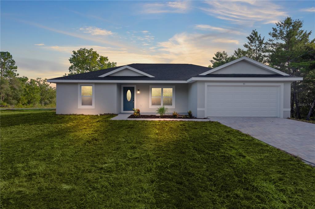 a front view of house with yard and green space