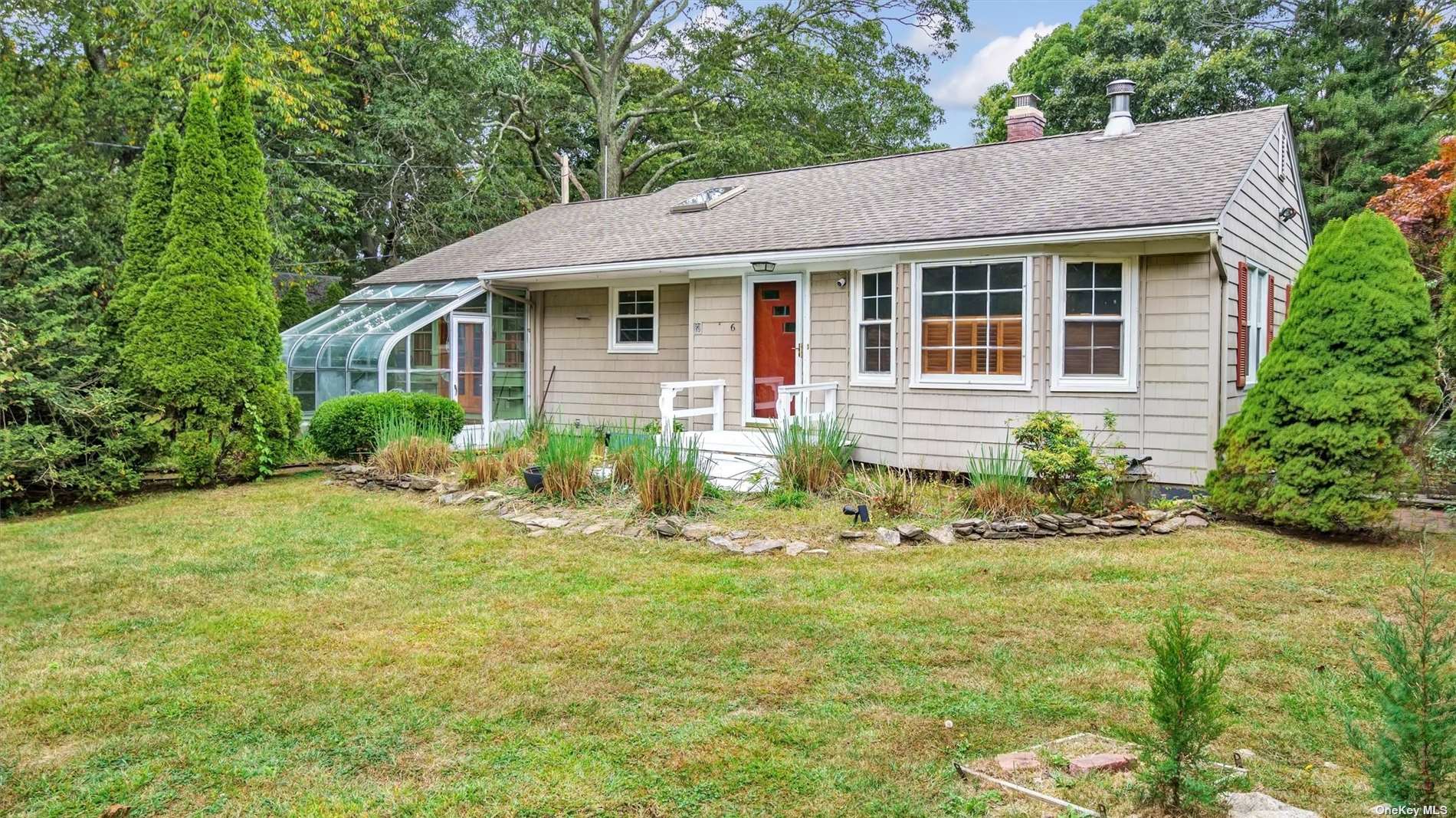 a front view of a house with garden