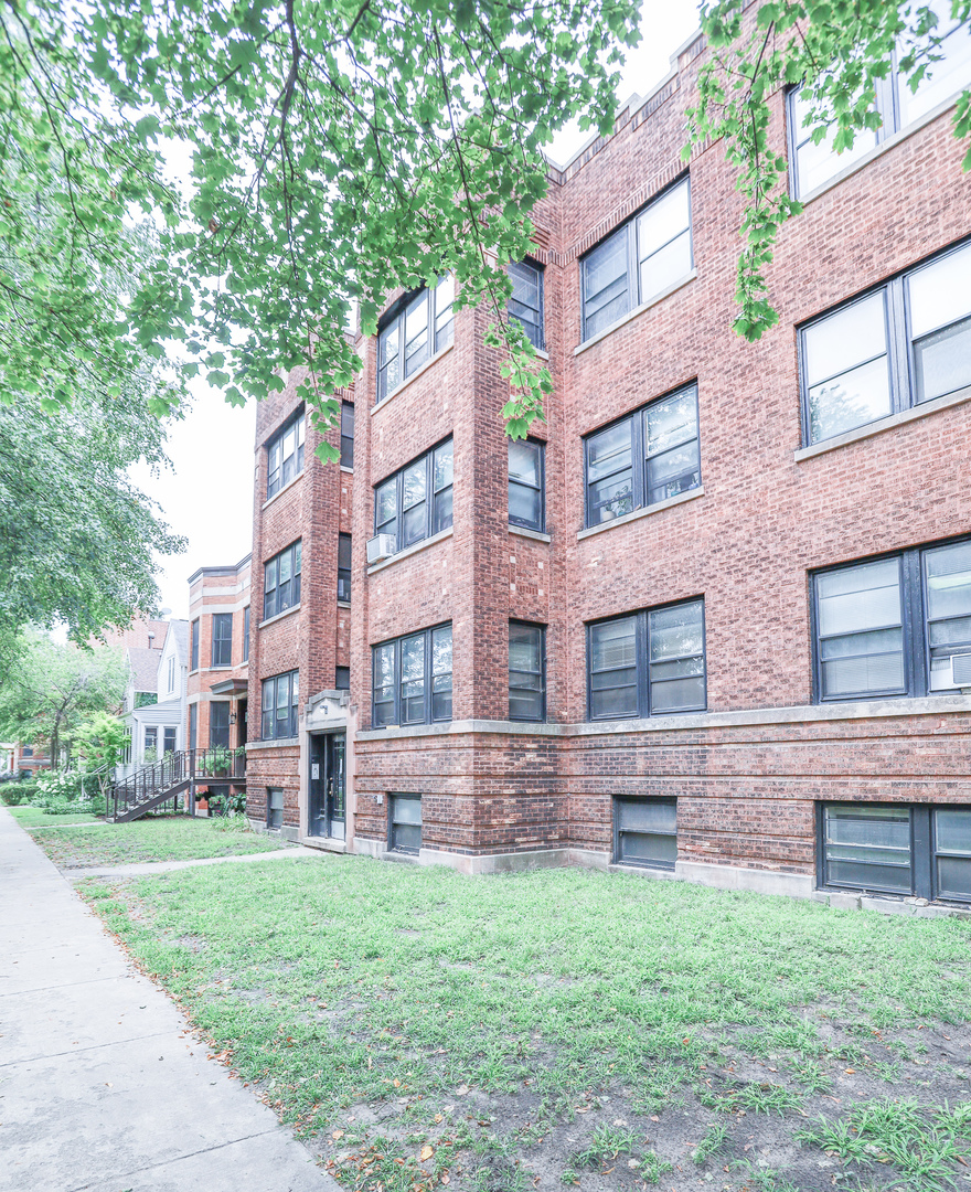 a brick building with a yard