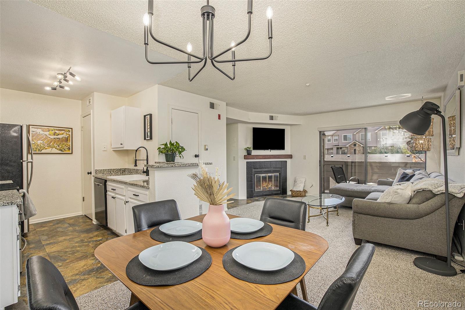 a living room with furniture a fireplace and a flat screen tv