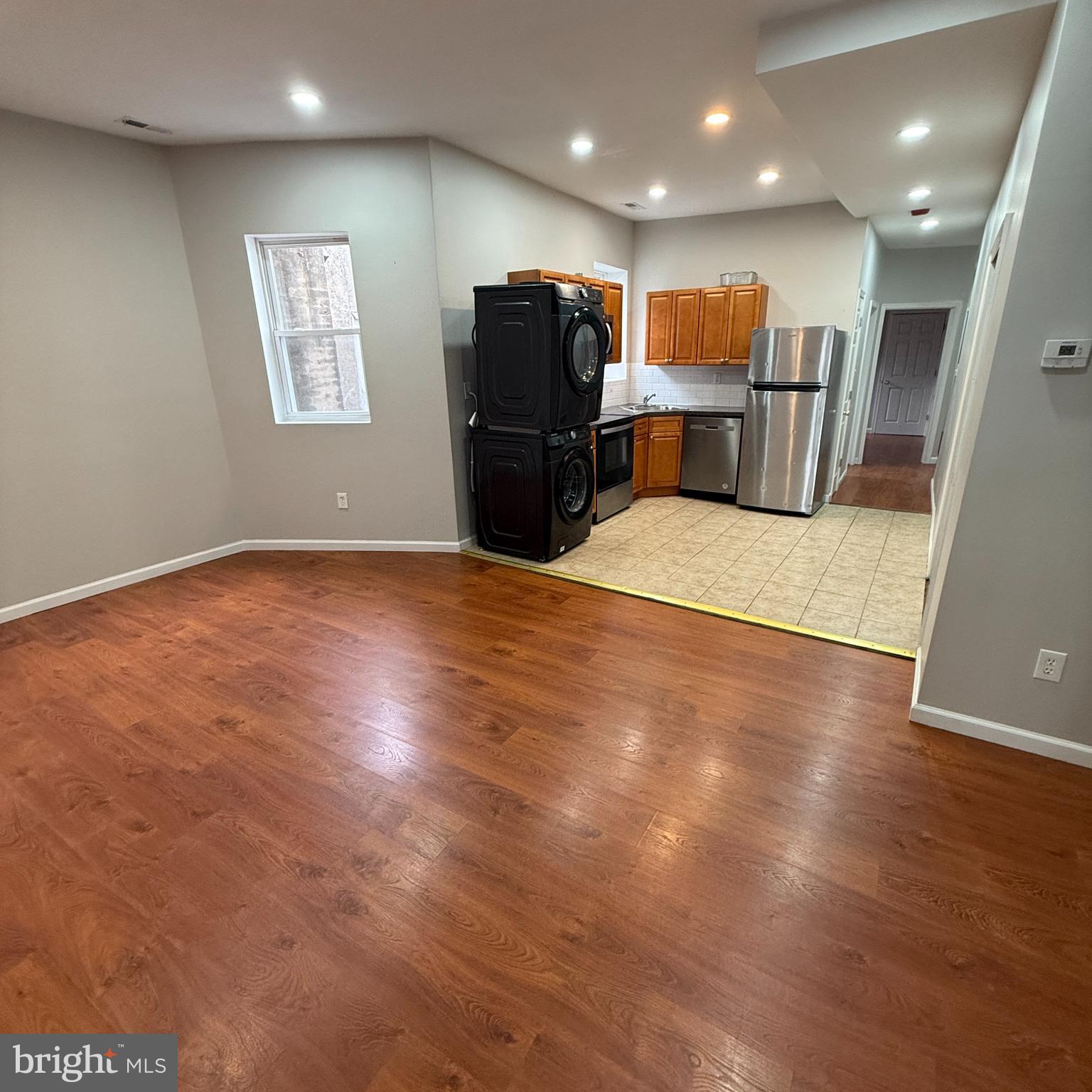 a view of kitchen with refrigerator microwave and wooden floor