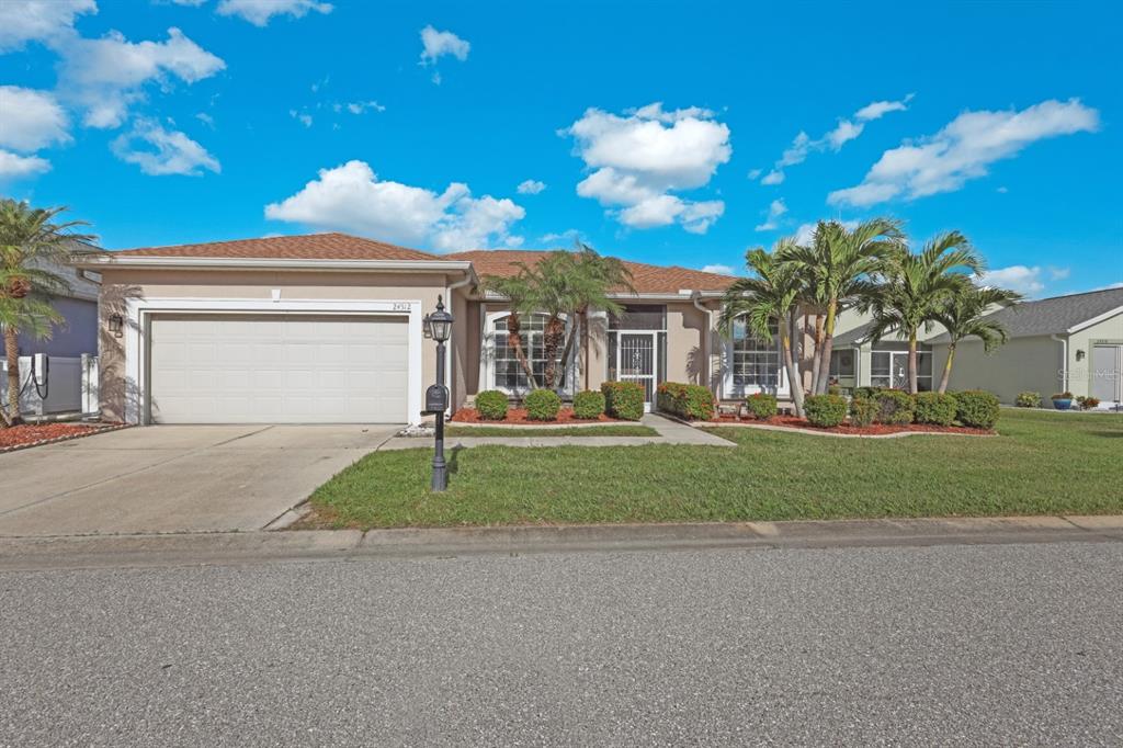 a front view of a house with a yard and garage