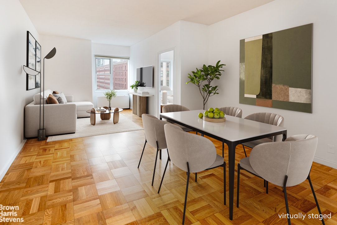 a living room with patio furniture and a potted plant