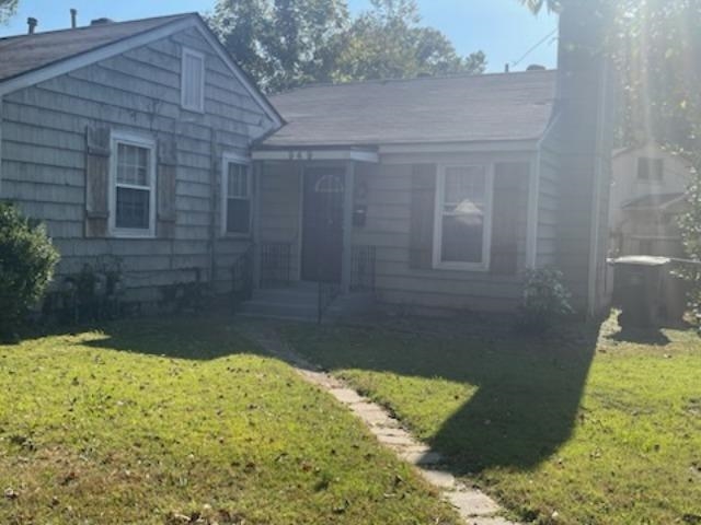 Bungalow-style house featuring a front lawn