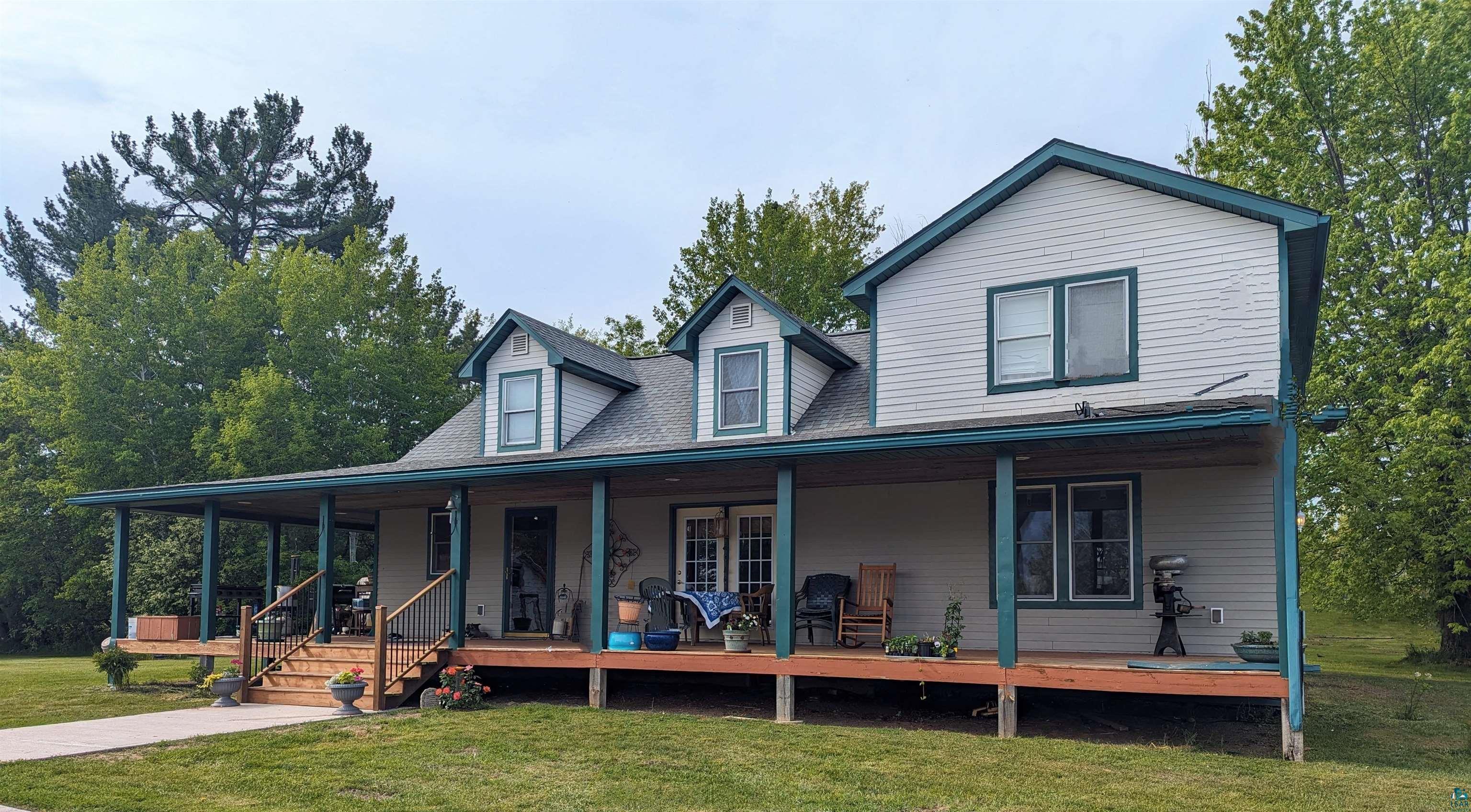 View of front of property with a front yard and covered porch