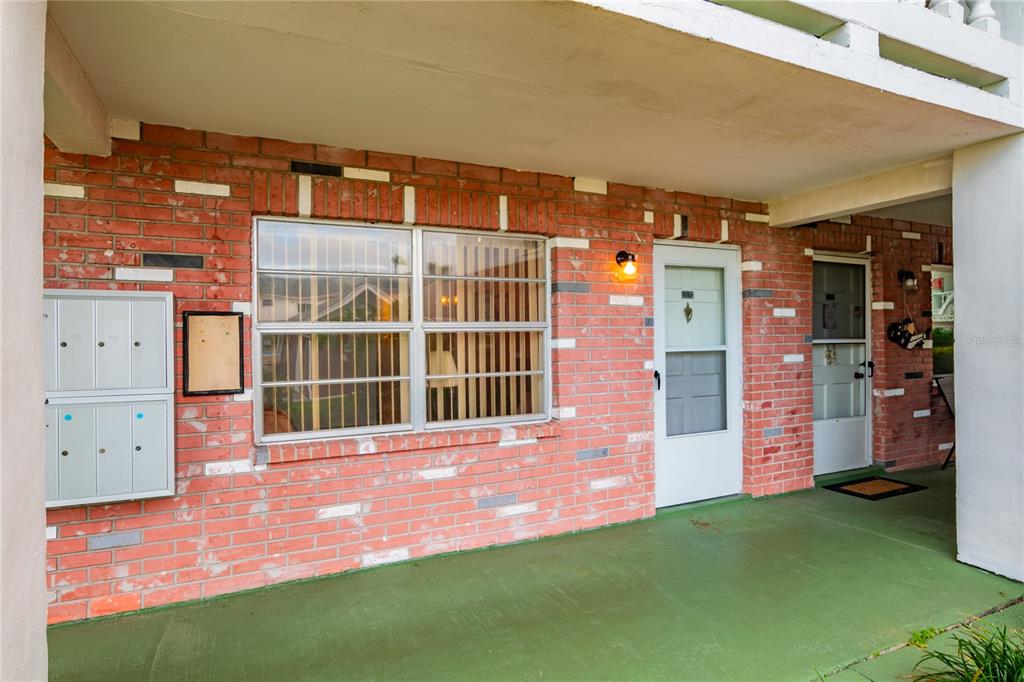 a view of backyard with tub and entryway