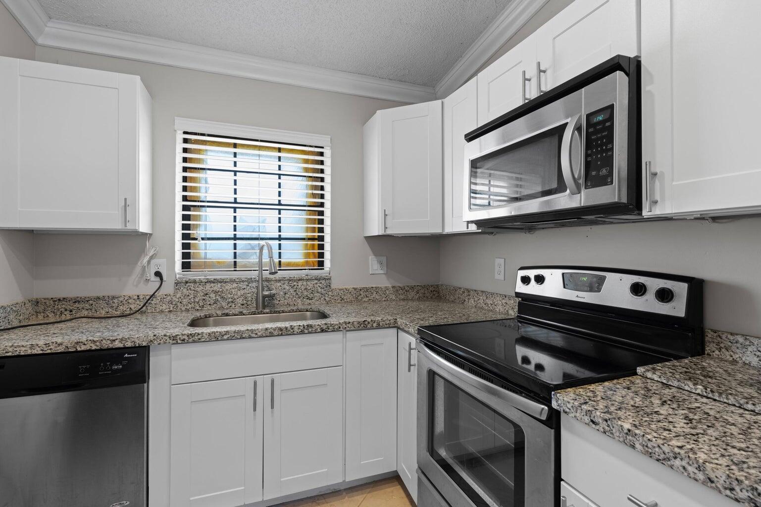 a kitchen with a stove microwave and sink