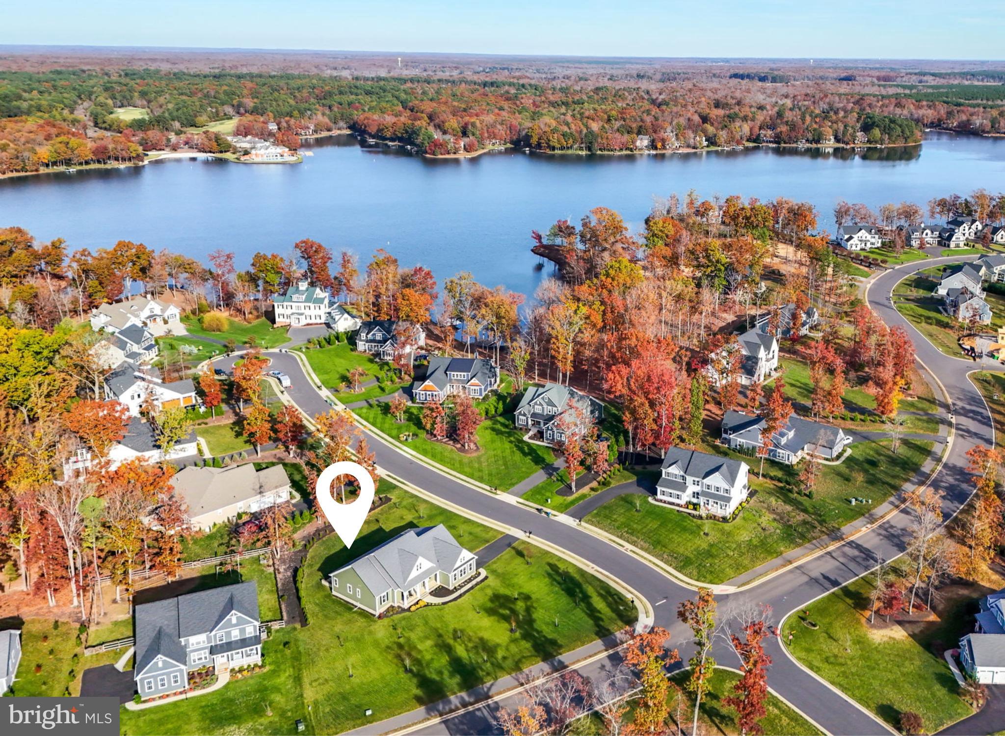 an aerial view of ocean and residential houses with outdoor space