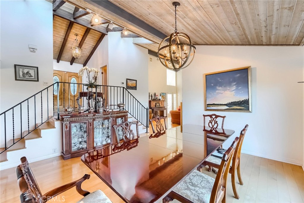 a view of a dining room with furniture wooden floor and chandelier