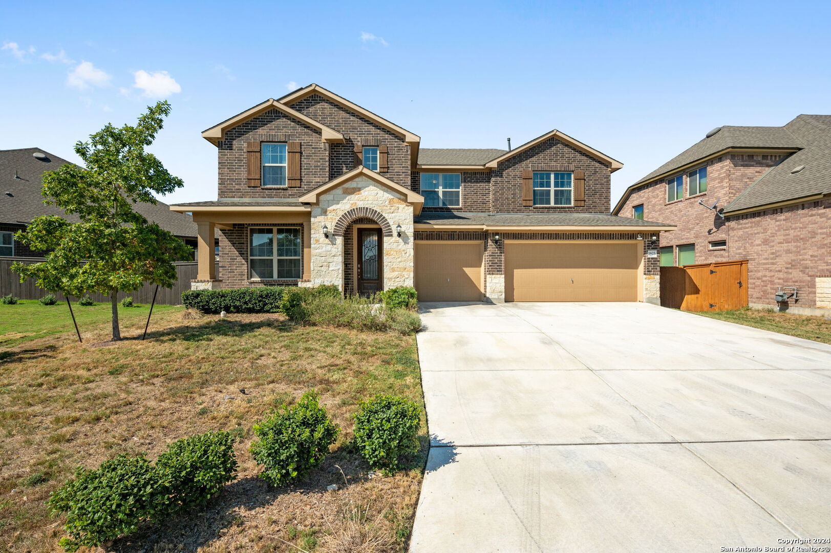 a front view of a house with a yard