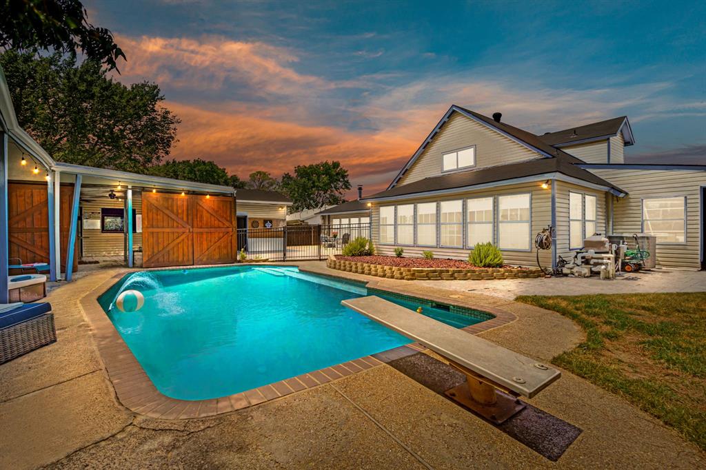 a view of a house with swimming pool and porch