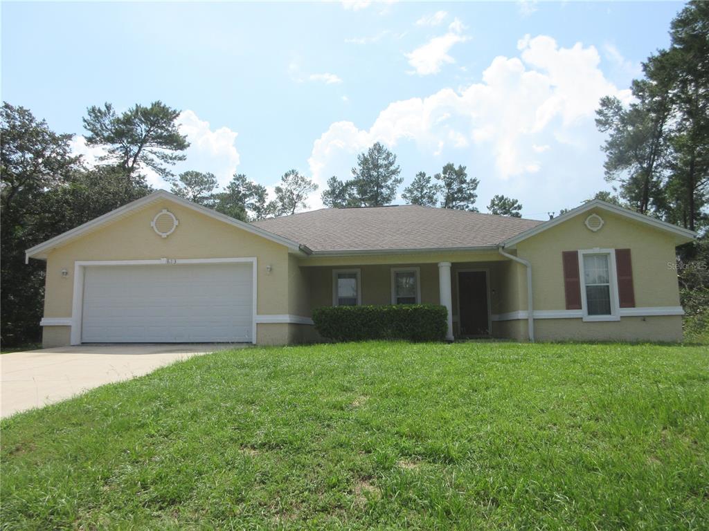 a front view of house with yard and green space