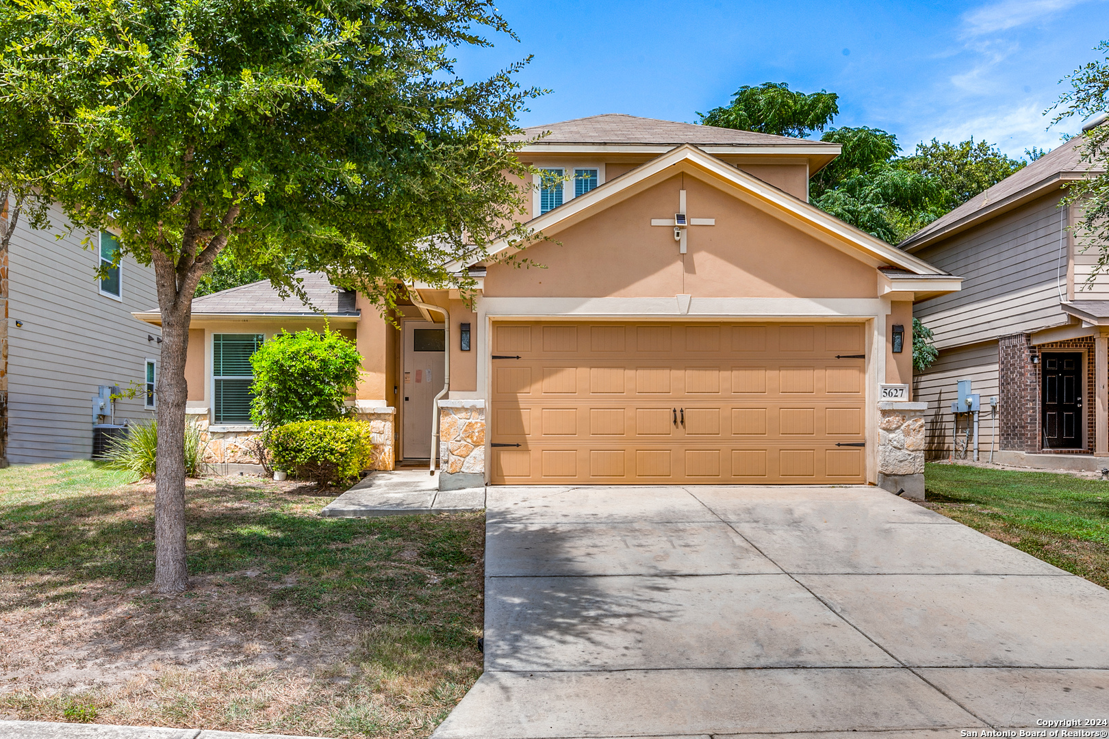 a front view of a house with a yard and garage