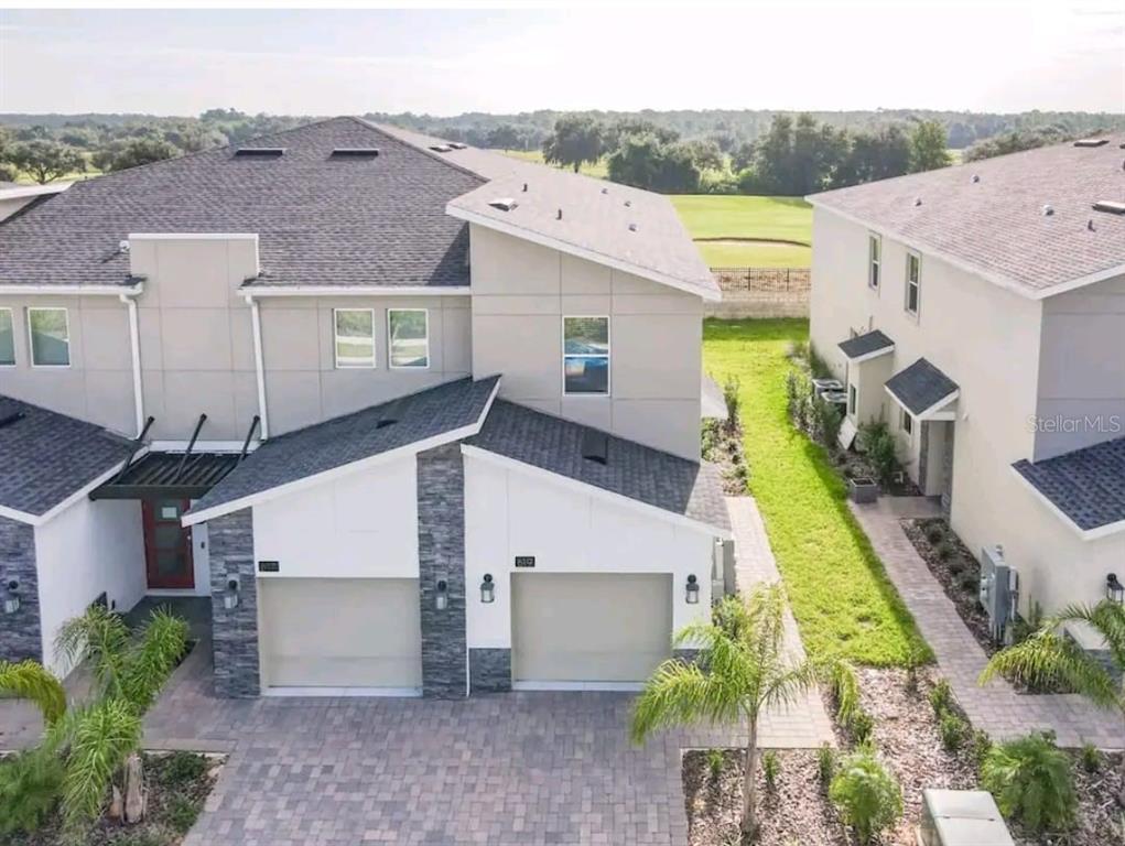 a aerial view of a house with a yard