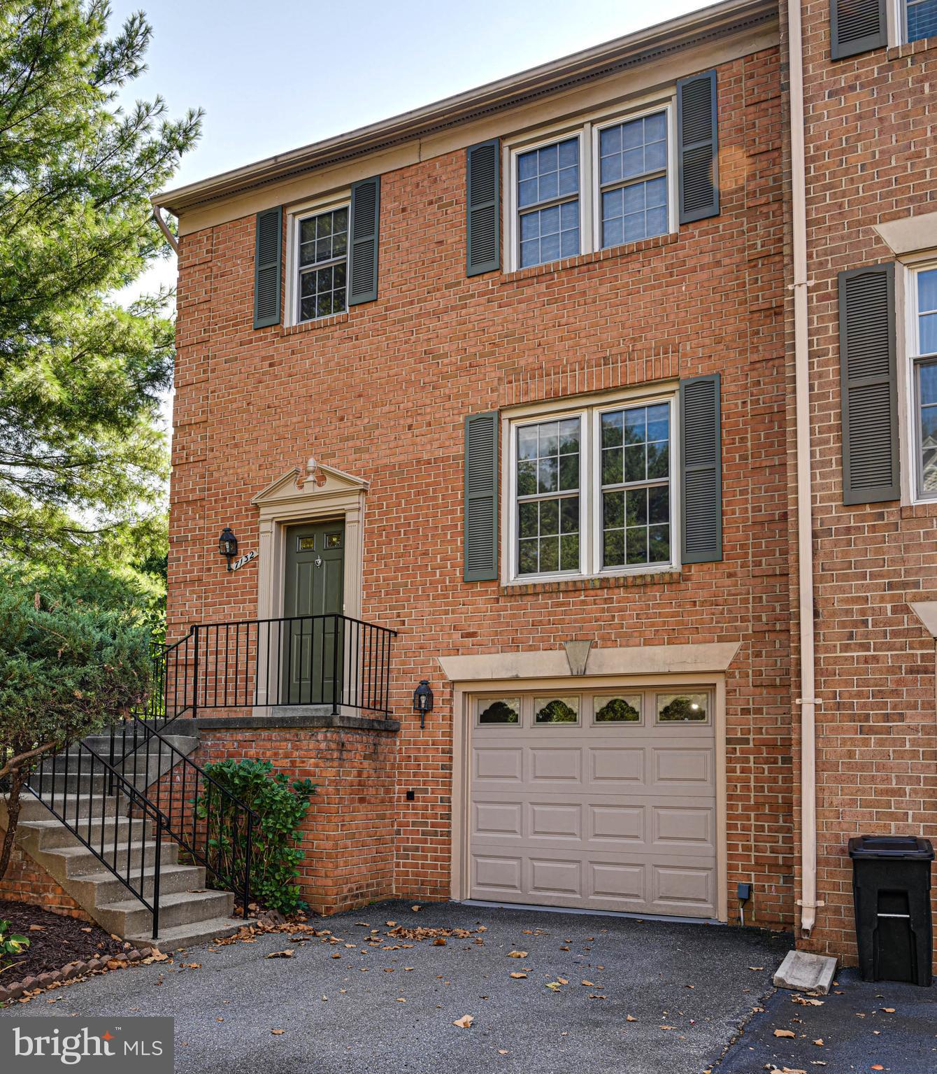 a front view of a house with a parking area