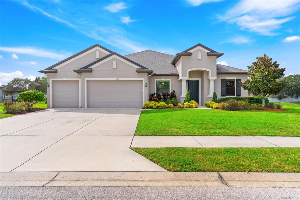 a front view of a house with a yard and garage